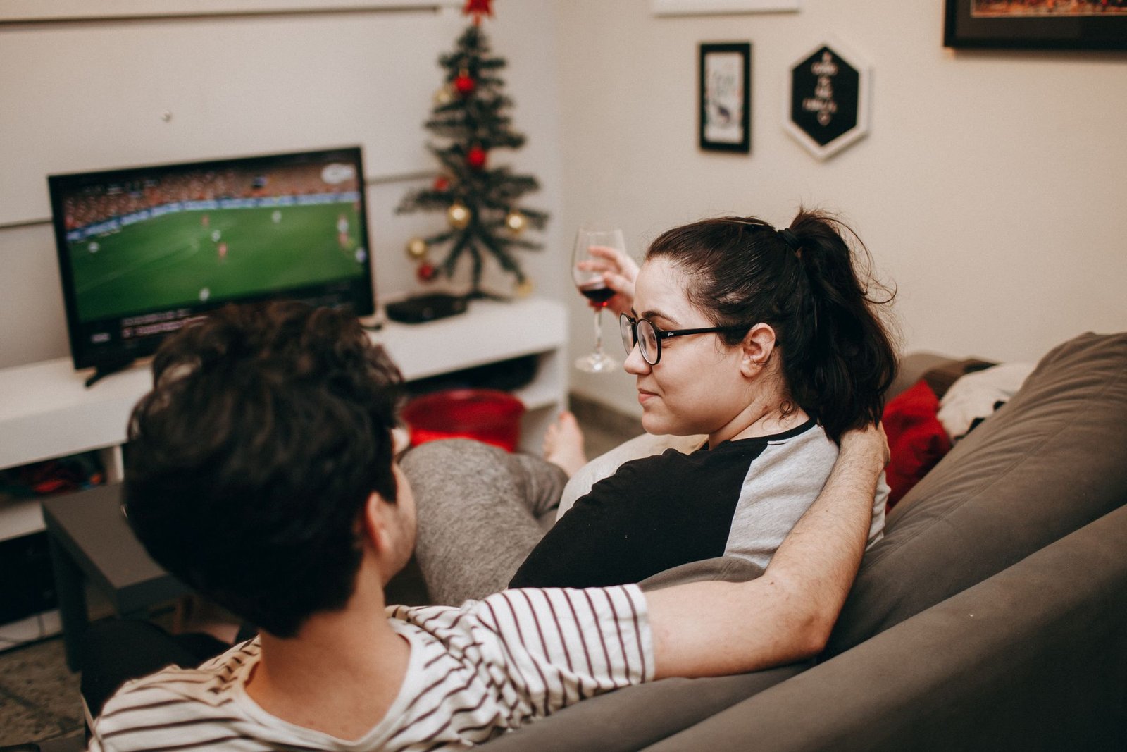 A couple relaxing on the sofa watching TV at home