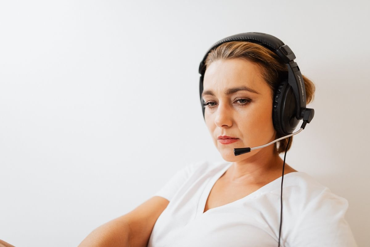 A support specialist wearing a headset helping a customer on the phone